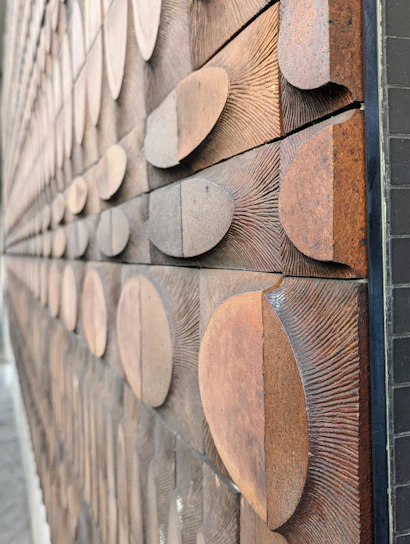 Close-up of a handcrafted wooden geometric wall art with natural wood textures.