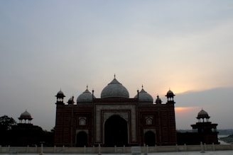 The synagogue’s exterior at sunset, with the city of Tiberias softly glowing in the background.