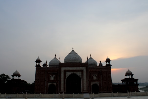 The synagogue’s exterior at sunset, with the city of Tiberias softly glowing in the background.