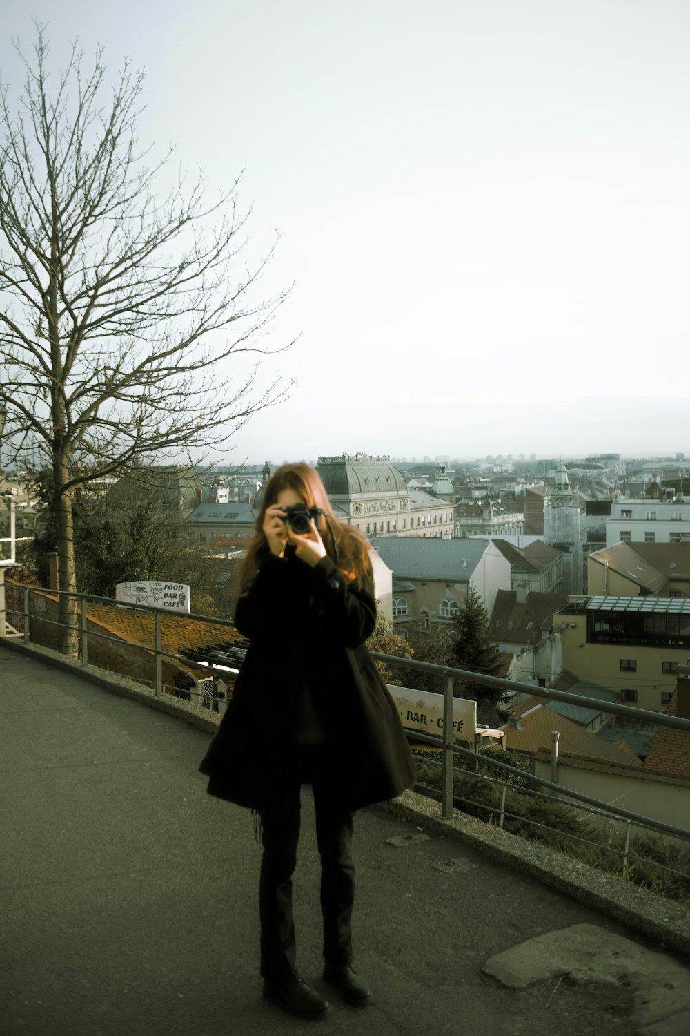 a woman in a black coat talking on a cell phone