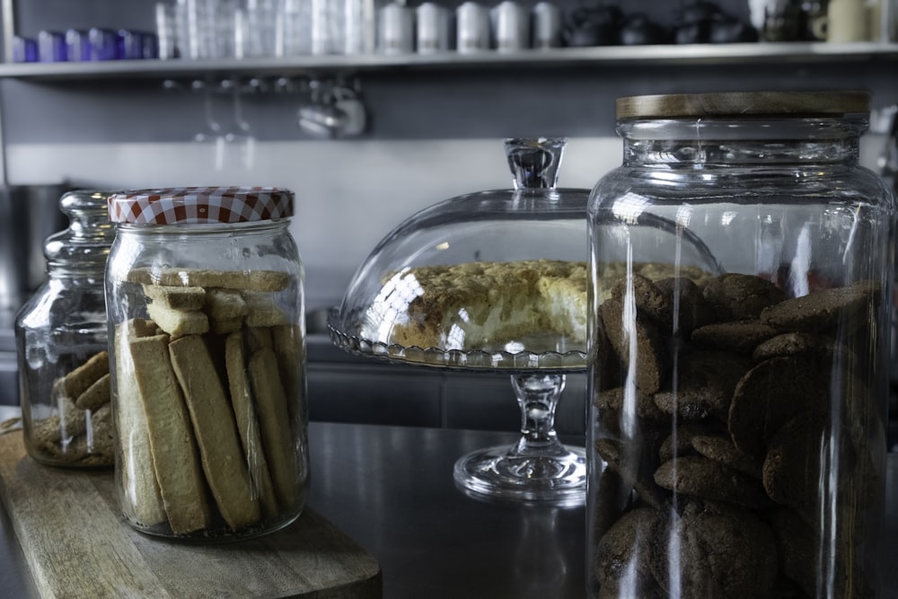 a kitchen counter topped with glass jars filled with food