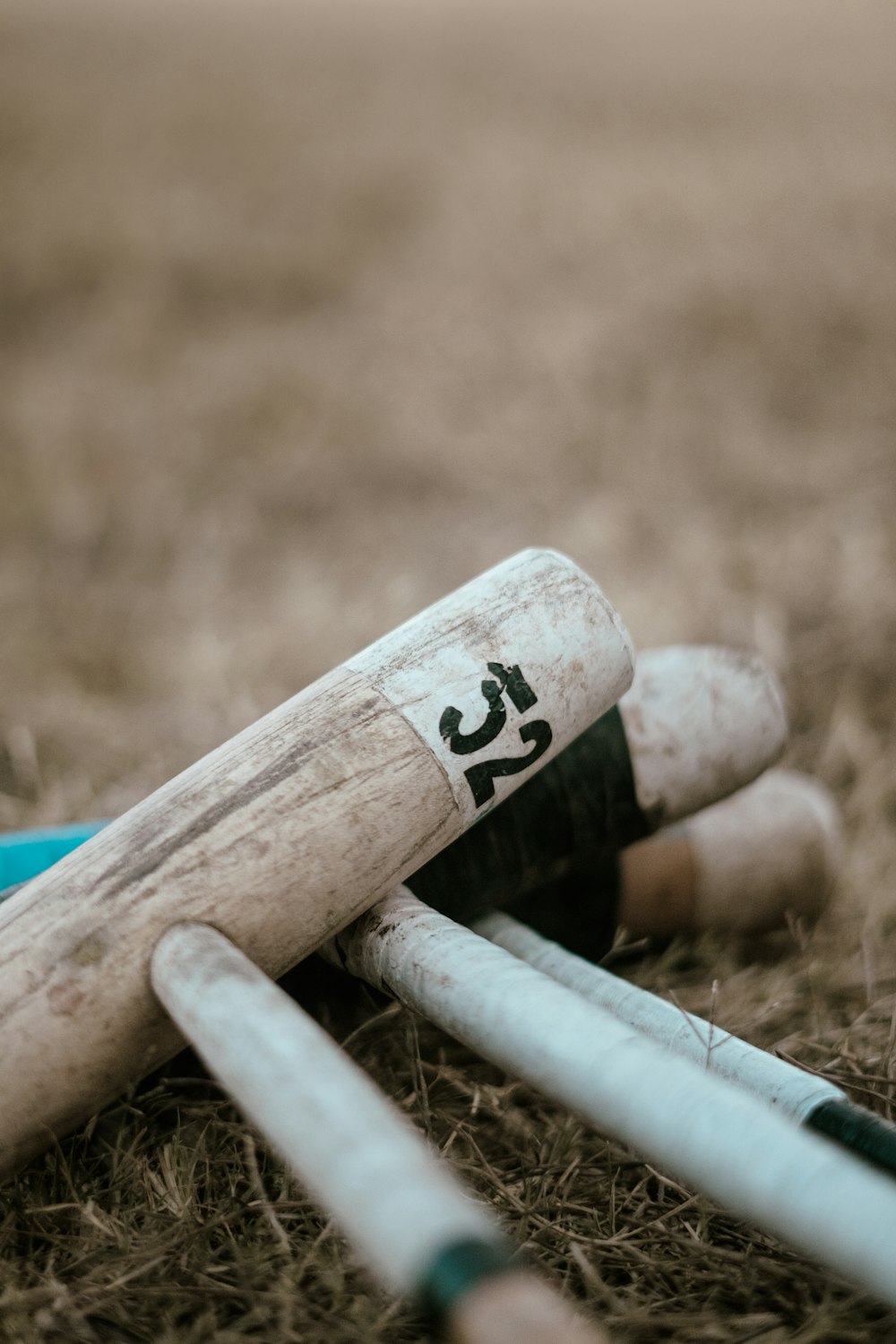 a bunch of baseball bats laying on the ground