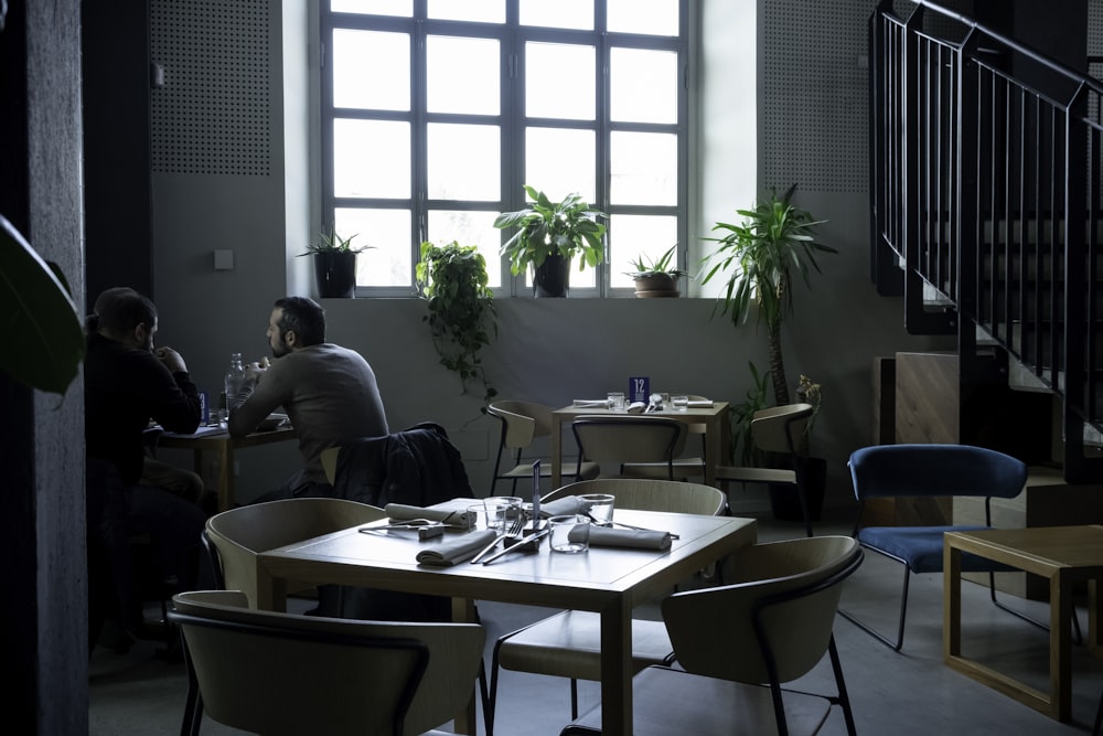 a couple of people sitting at a table in a room