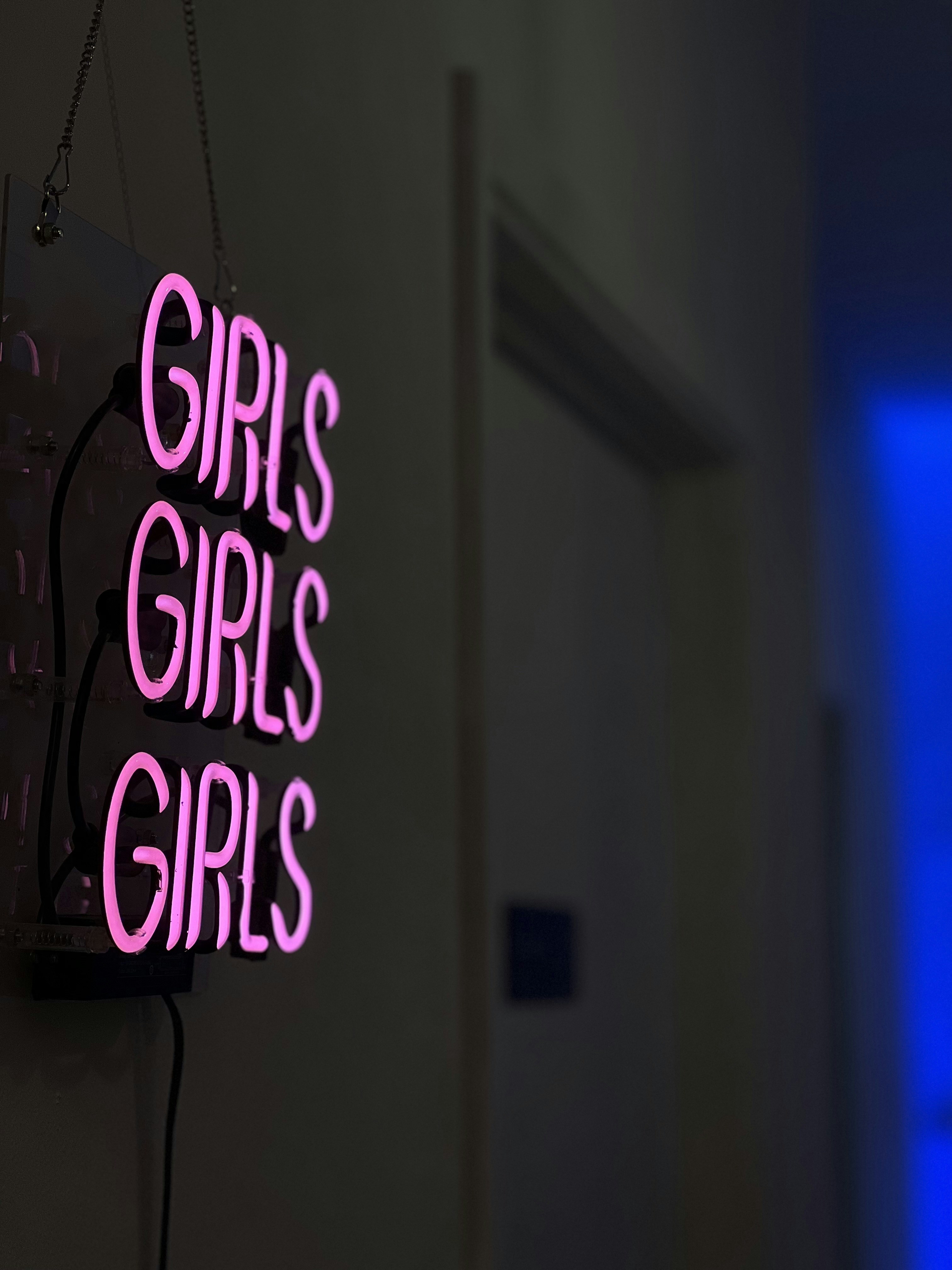 a neon sign hanging from the side of a wall