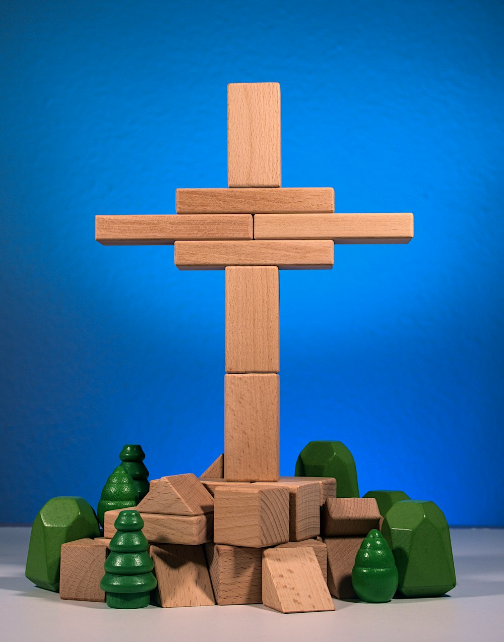 a wooden cross surrounded by small trees