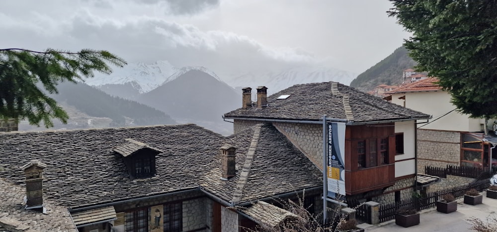 a view of a village with mountains in the background