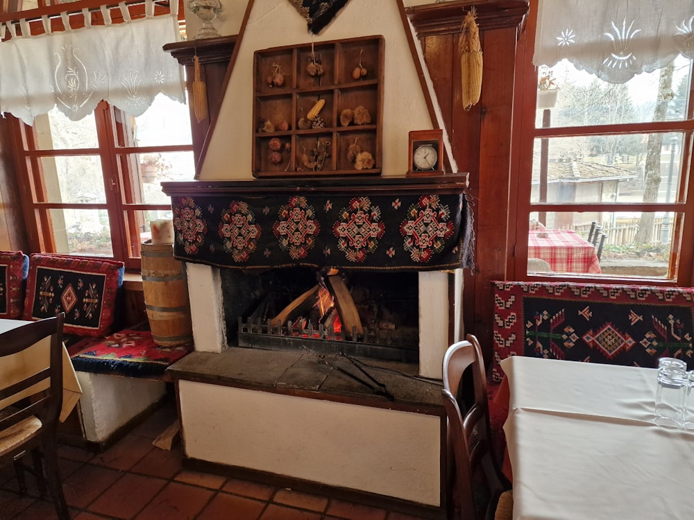 a fire place in a restaurant with tables and chairs