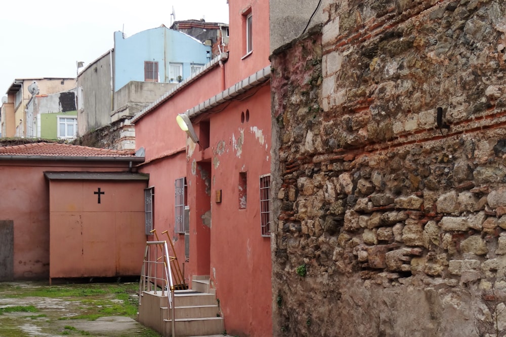 a narrow alleyway with a cross on the door