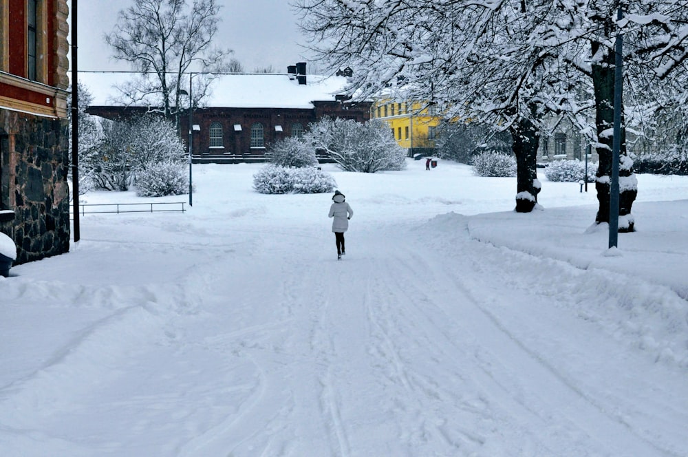 a person walking down a snow covered street