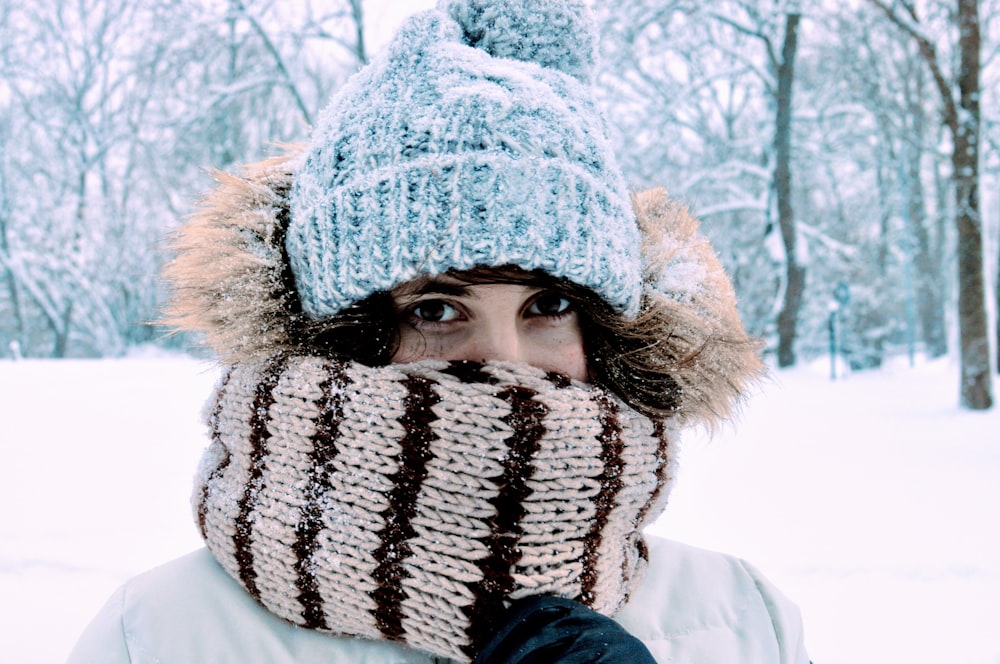 a woman wearing a knitted hat and scarf