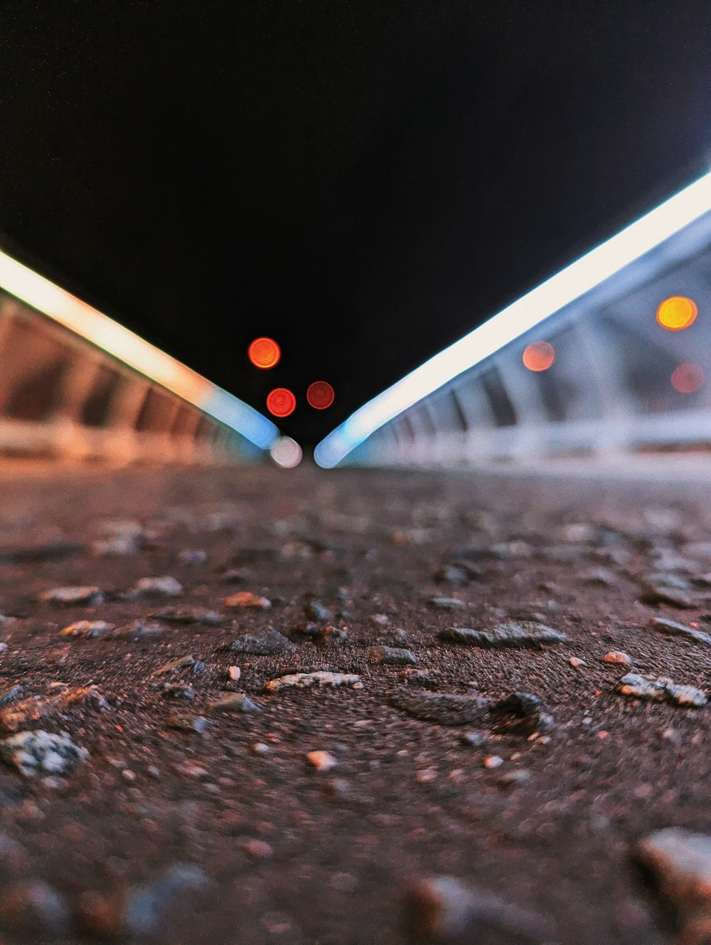 a close up of a street with lights in the background