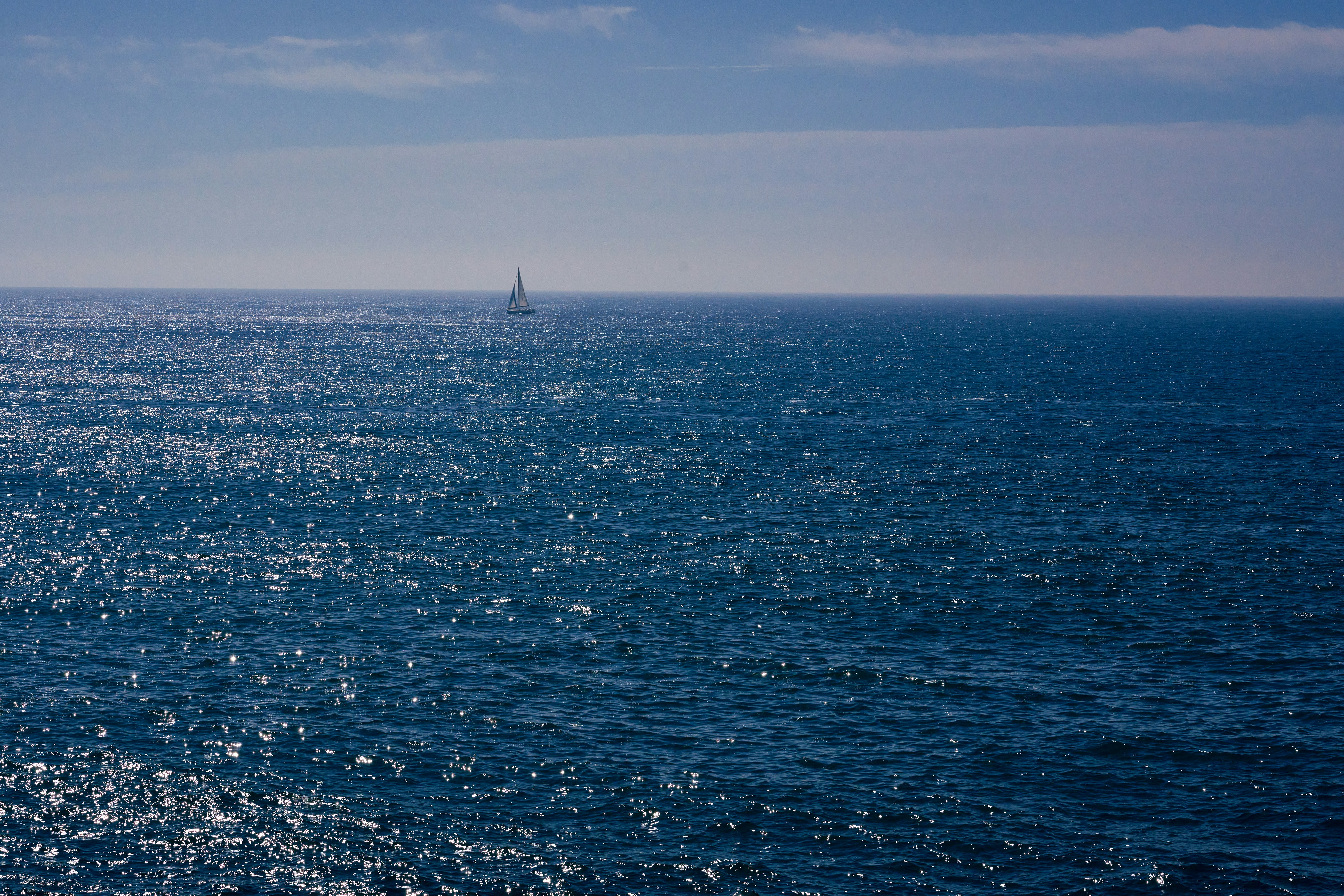 a sailboat in the middle of the ocean