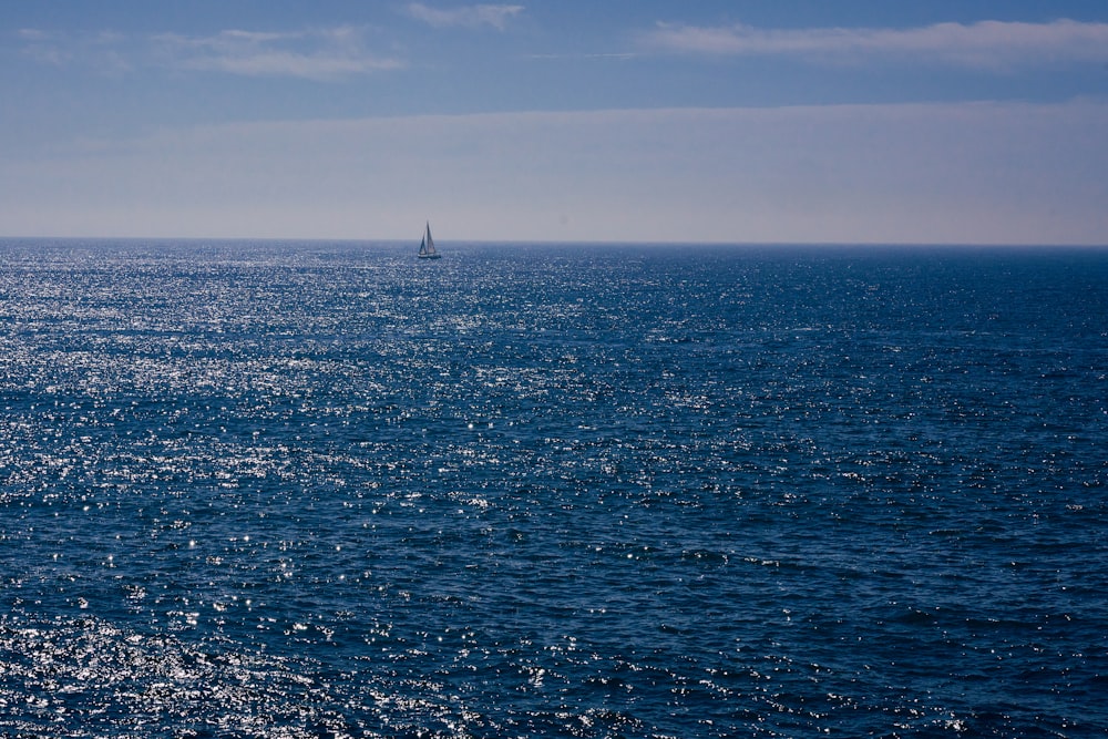 a sailboat in the middle of the ocean