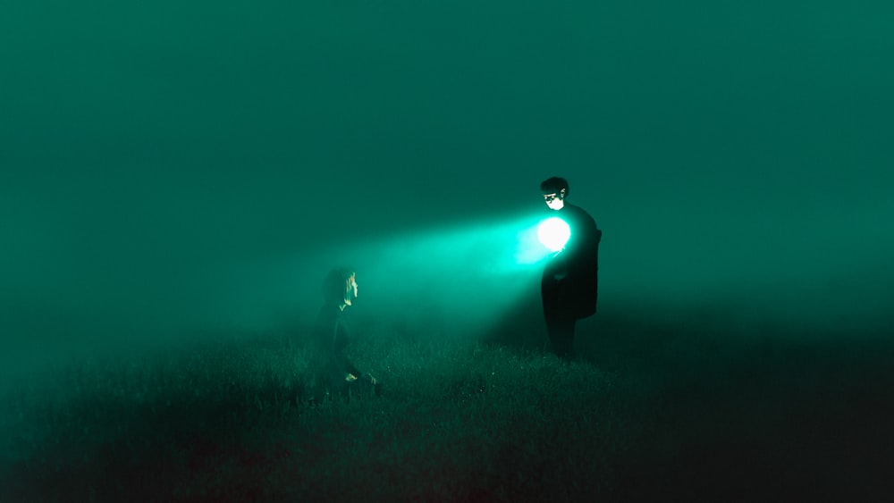 a man and a woman standing in a foggy field