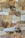 An arrangement of various natural stones, each with unique textures and colors, forming a mosaic-like pattern. The stones vary in shades of brown, tan, gray, and some darker hues, separated by thin mortar lines.