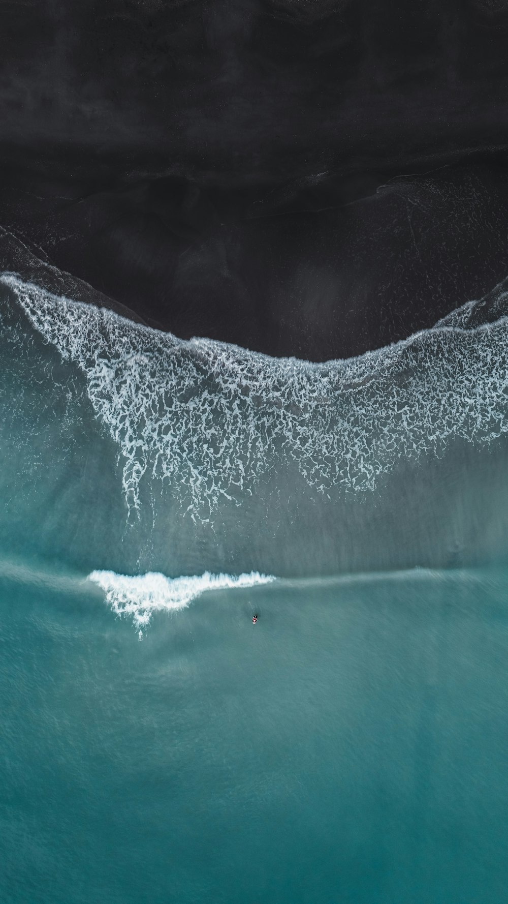 a person riding a surfboard on a wave in the ocean