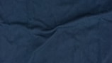 Close-up of luxurious fabric textures in deep blue and metallic tones.