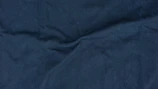 Close-up of luxurious navy blue twill fabric with fine texture.