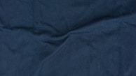 A close-up of a luxurious silk fabric in deep blue.