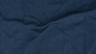 A close-up of a luxurious silk fabric in deep blue.