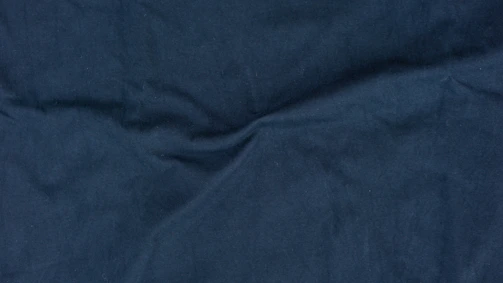 Close-up of rich navy formal fabric with intricate weave texture.