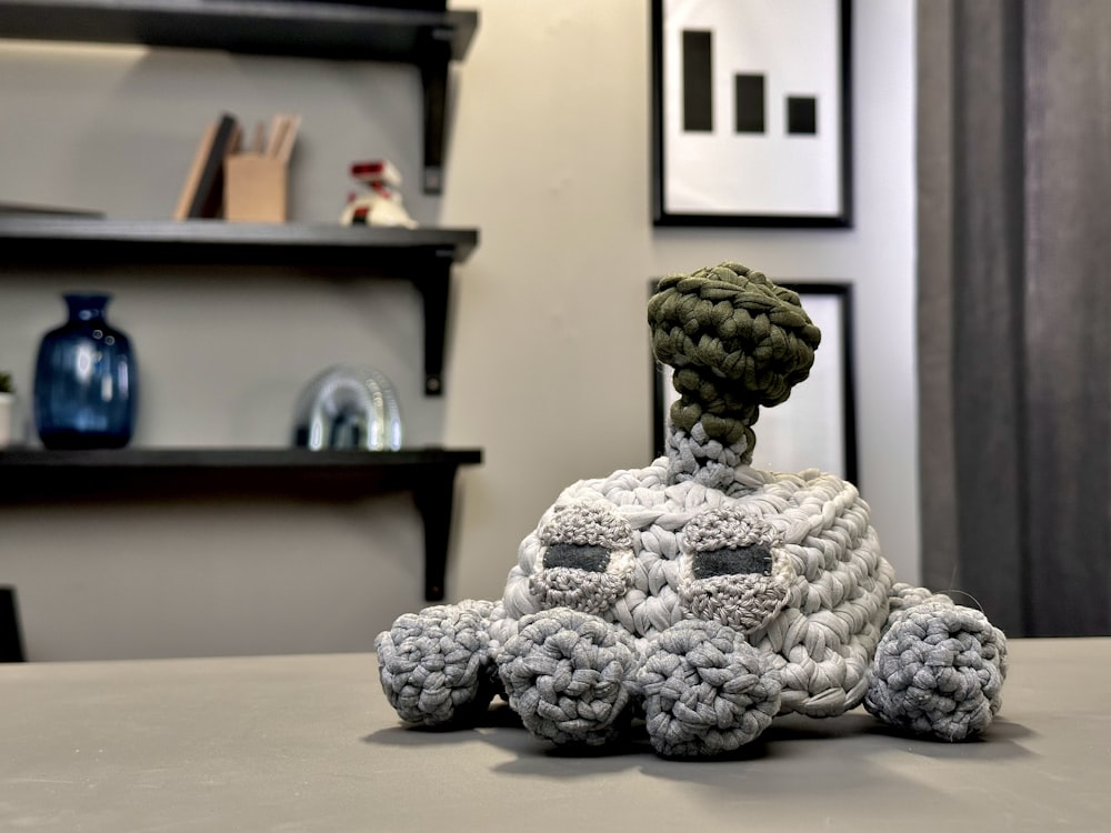 a crocheted toy is sitting on a table