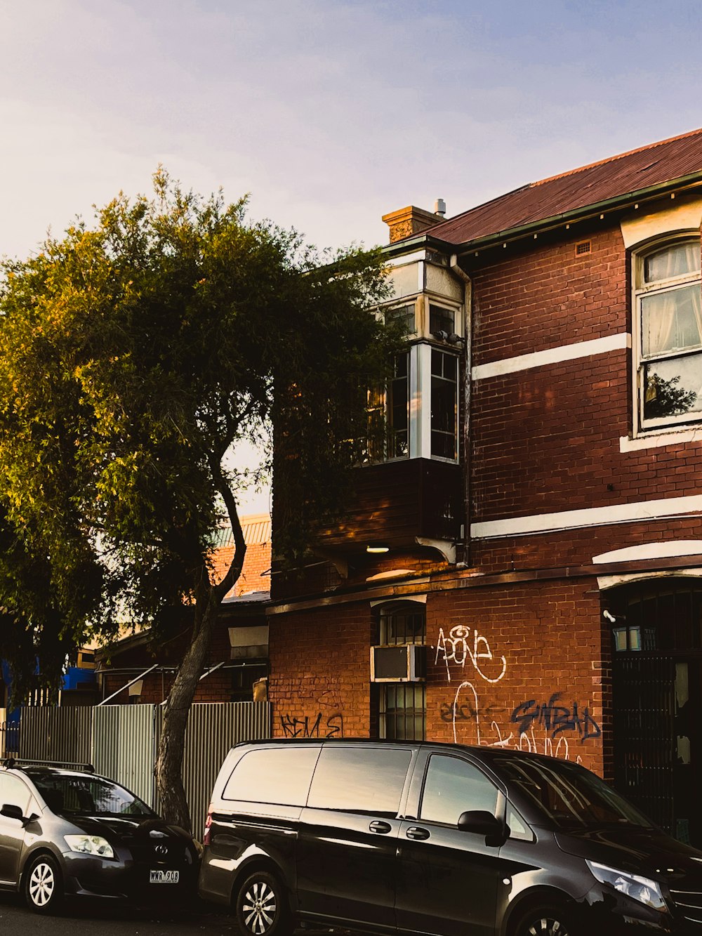 a van parked in front of a brick building