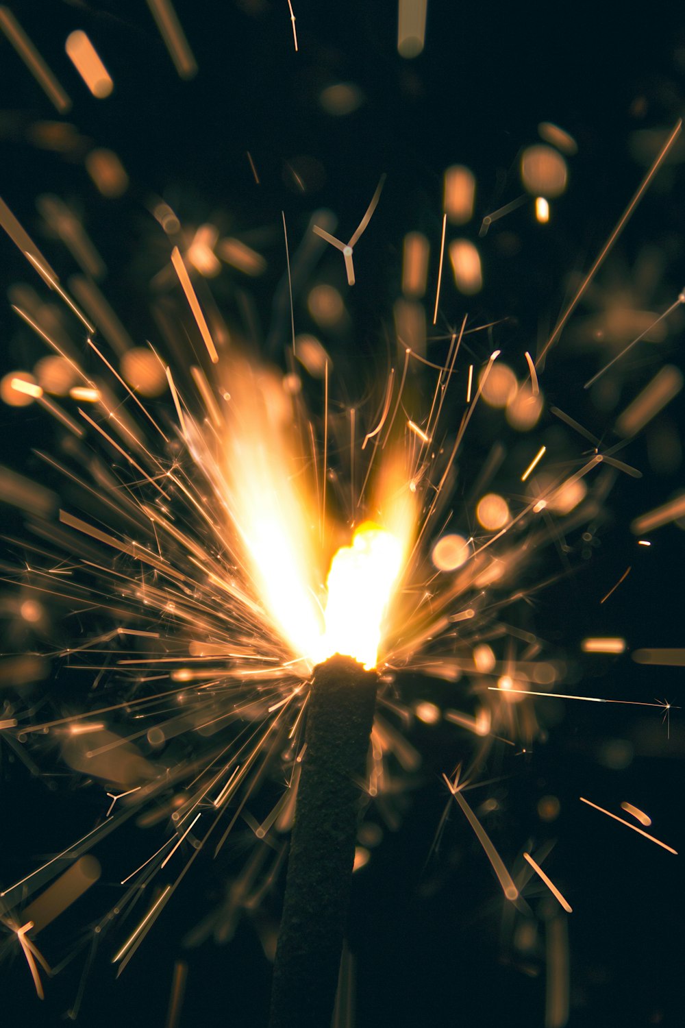 a close up of a sparkler on a black background