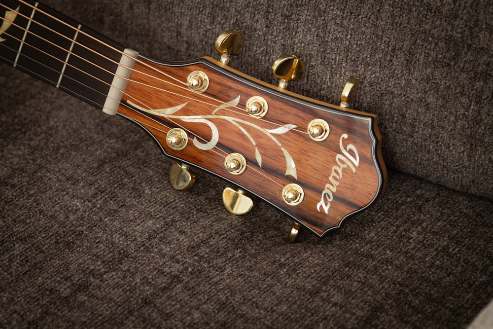 a close up of a guitar with a name on it
