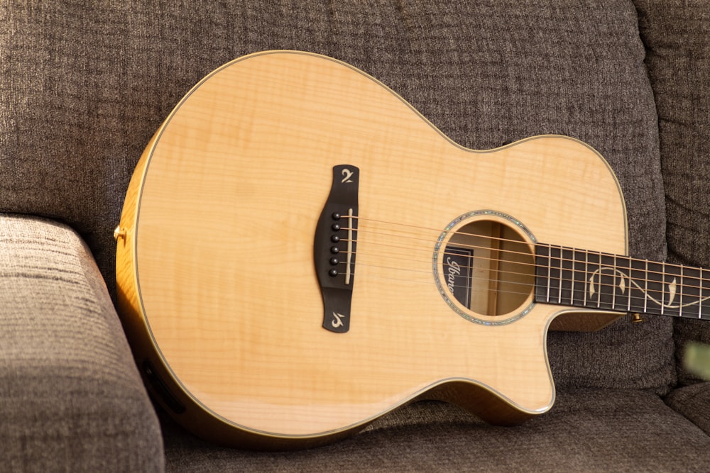 a close up of a guitar on a couch