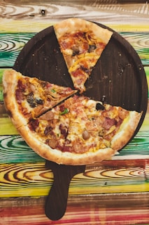A rustic wooden board displaying a variety of pizza slices with different toppings, inviting and ready to eat.