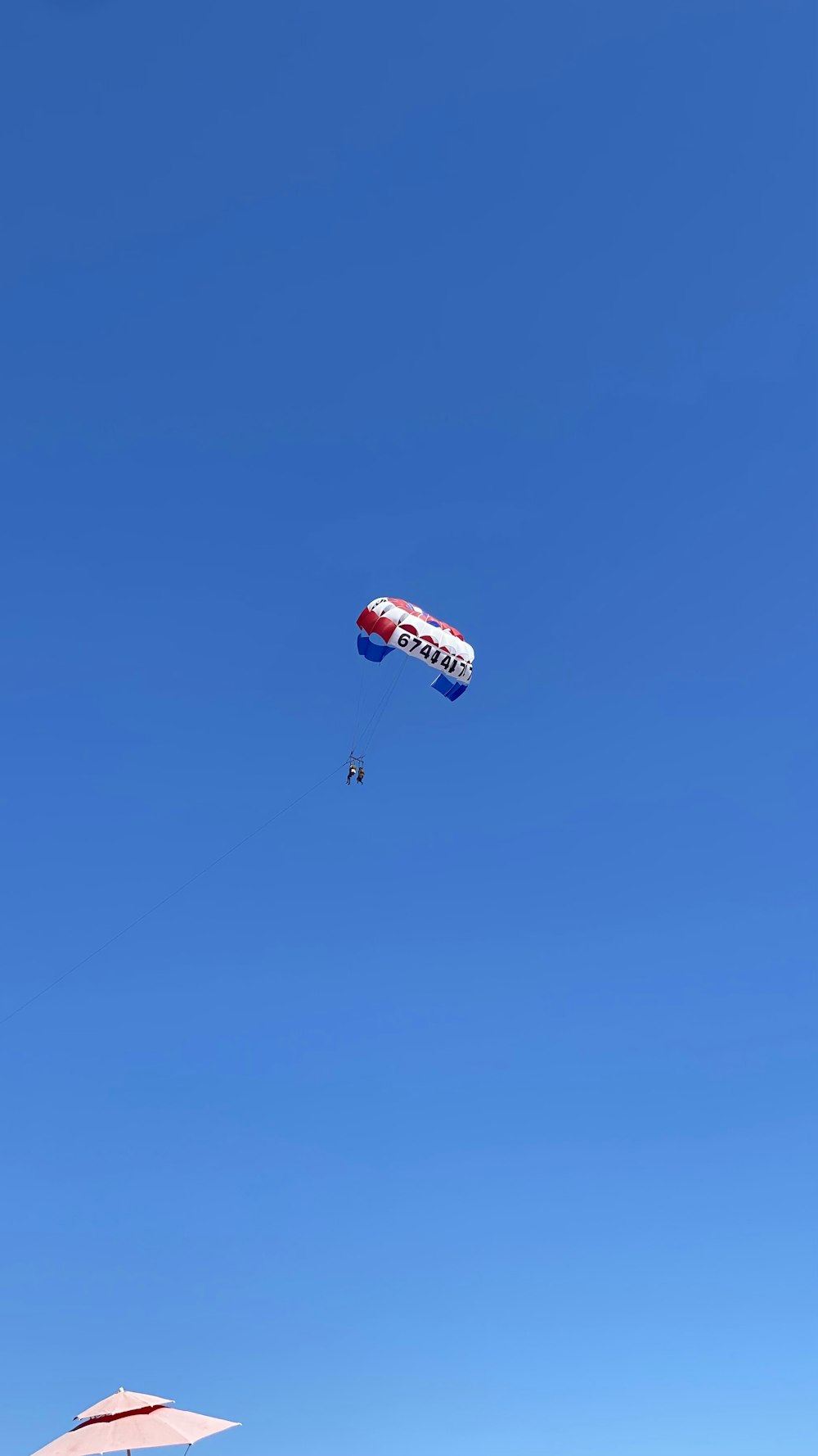 a group of people on a beach flying kites