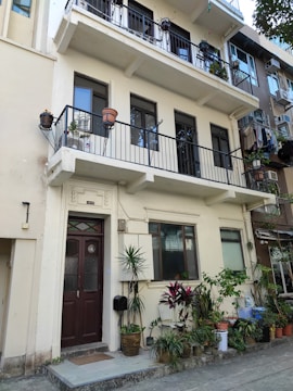 A multi-story builder floor house with a small garden in Janakpuri.
