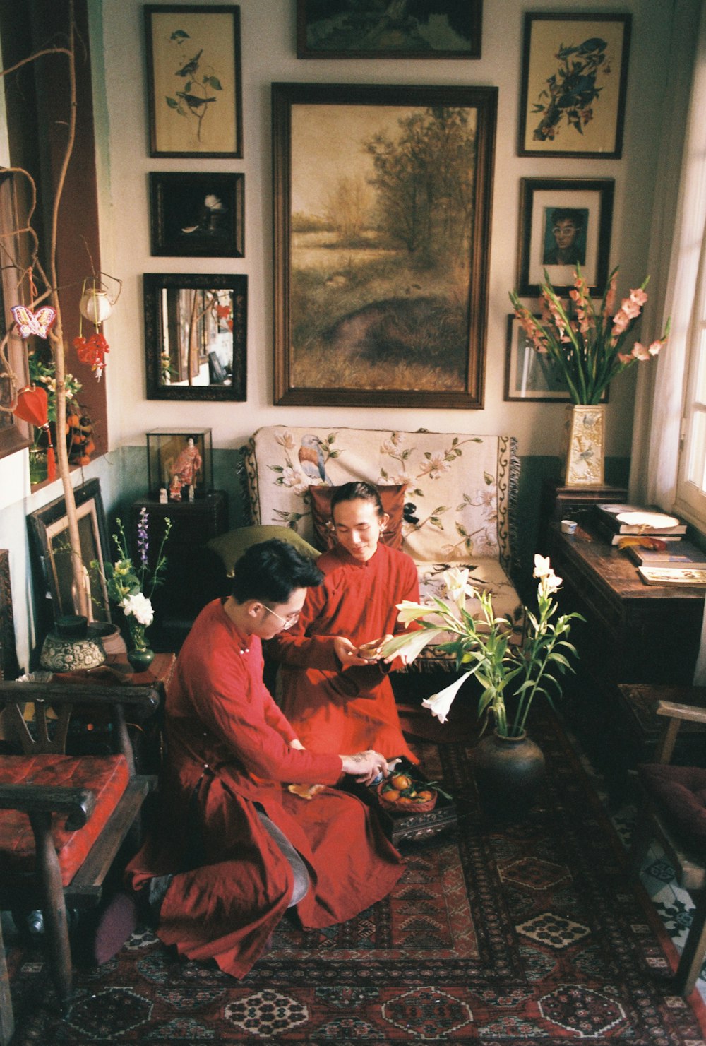 a couple of women sitting next to each other in a living room