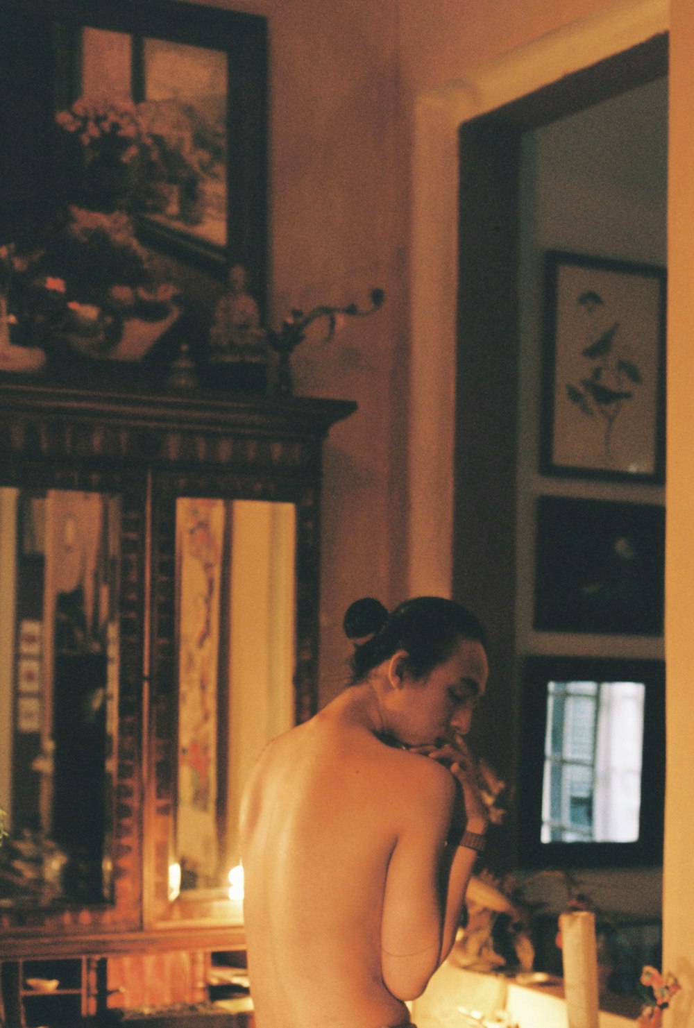 a naked woman standing in front of a mirror