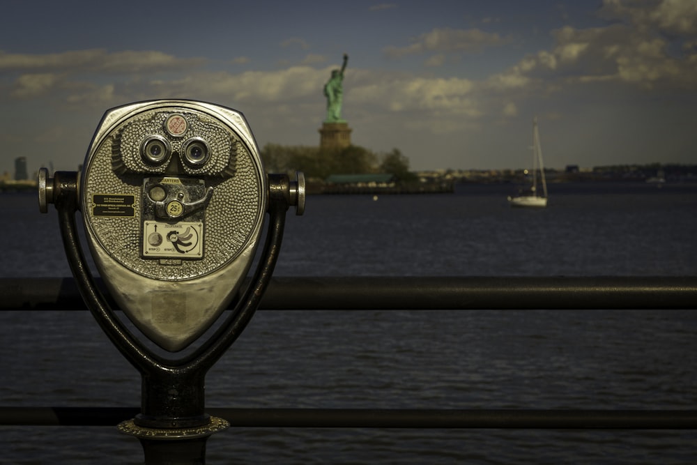 a coin operated binoculars overlooks the statue of liberty