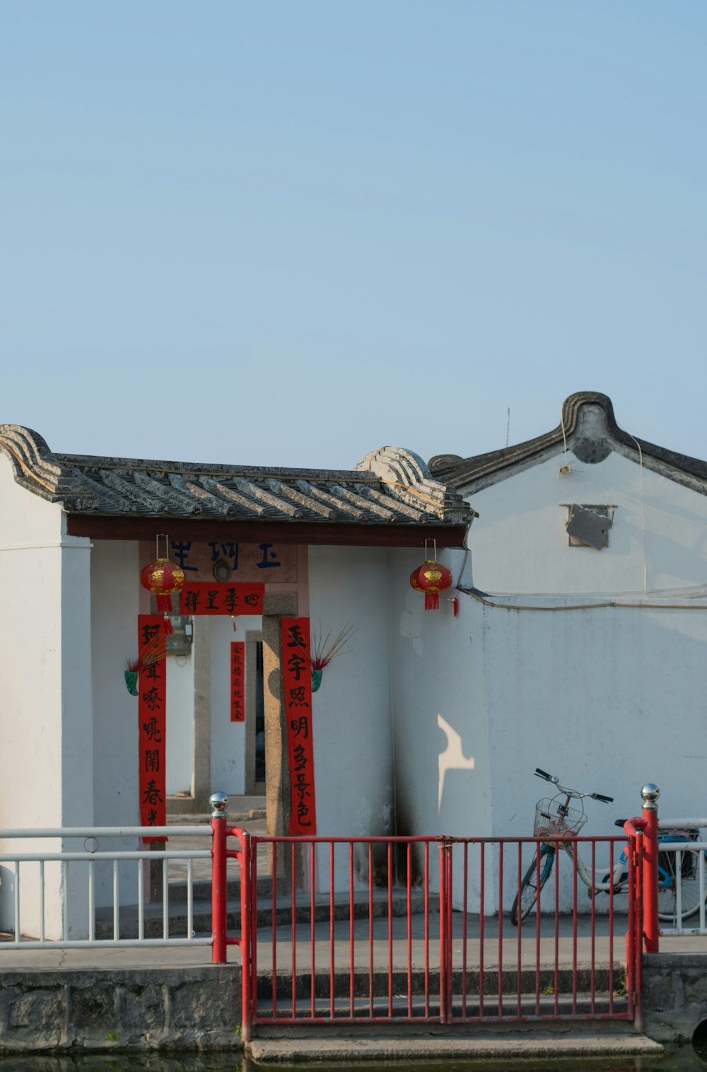 a white building with a red fence around it