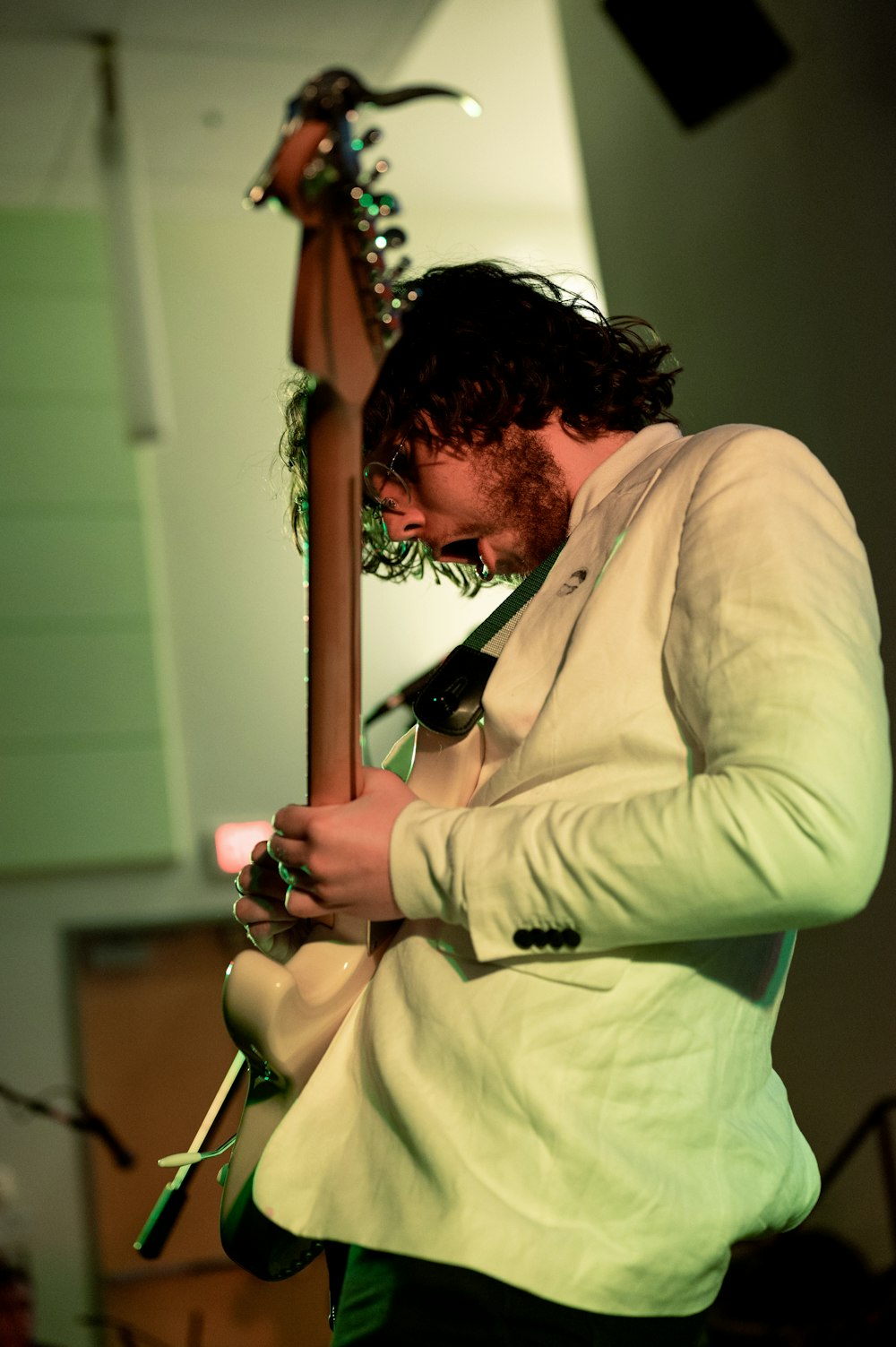 a man with a beard playing a guitar