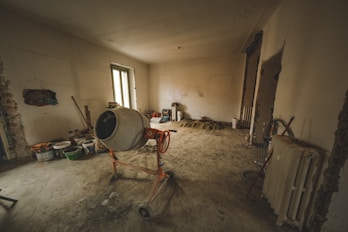 a dirty room with a fan, radiator, and a radiator