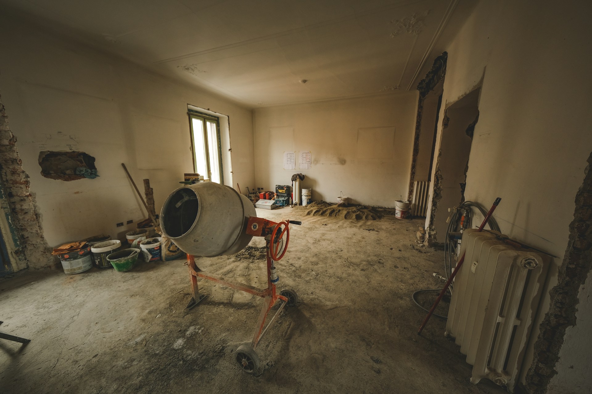 a dirty room with a fan, radiator, and a radiator