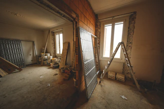 a room with a ladder and a window in it