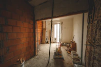 a room with a brick wall and a doorway