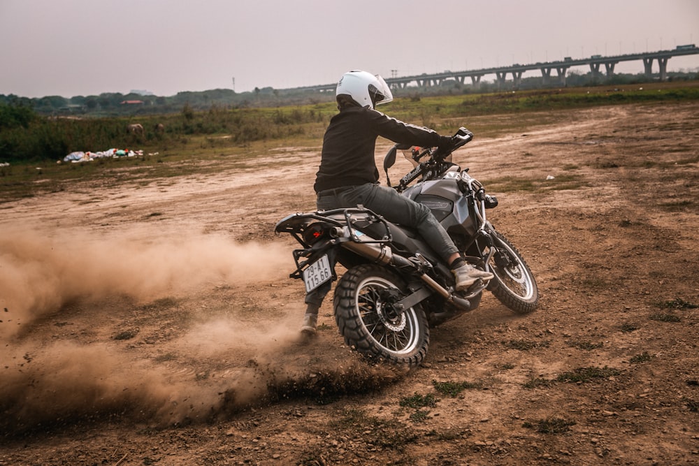 a person riding a motorcycle on a dirt road