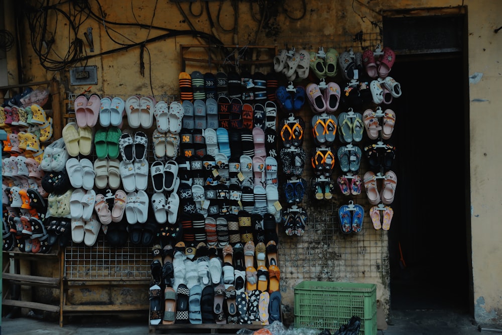 a bunch of shoes that are on a wall