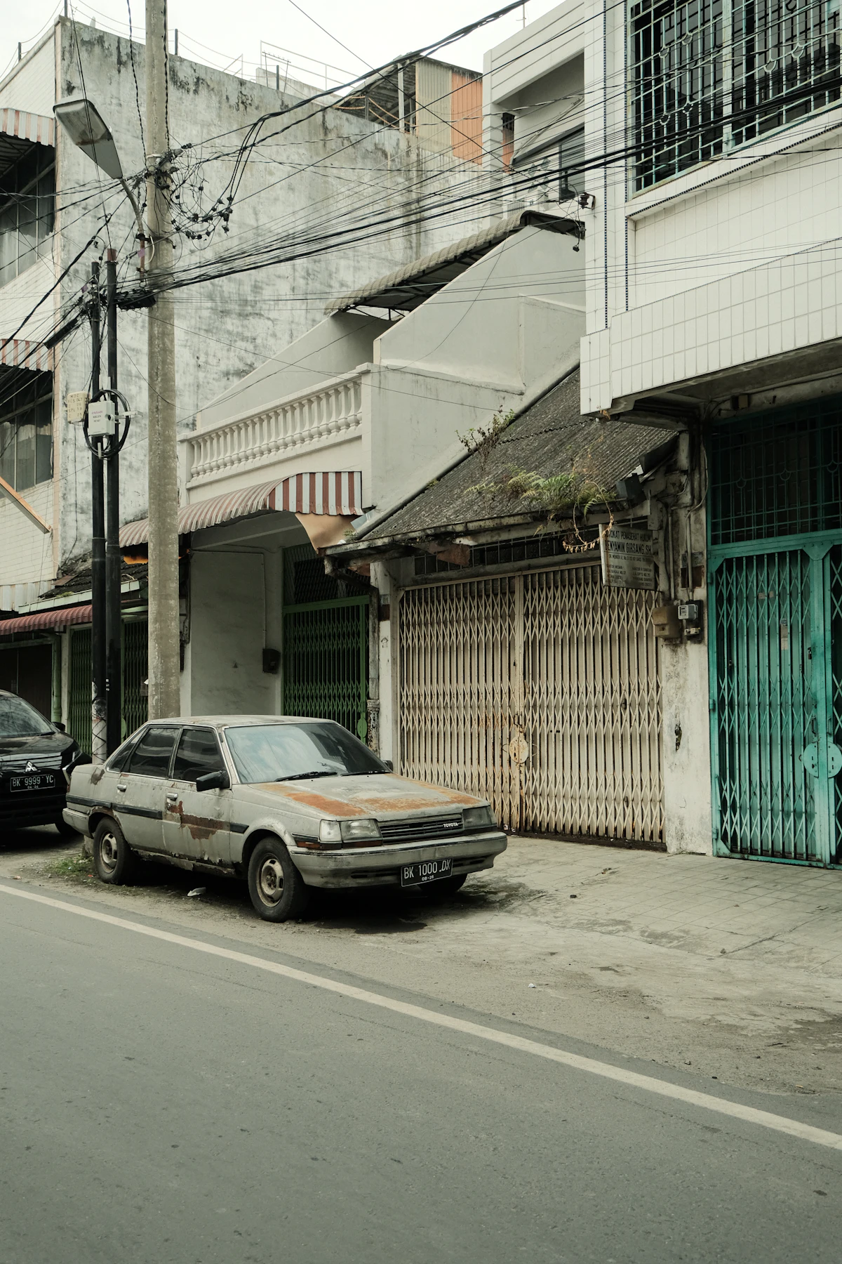 Older cars parked on a street