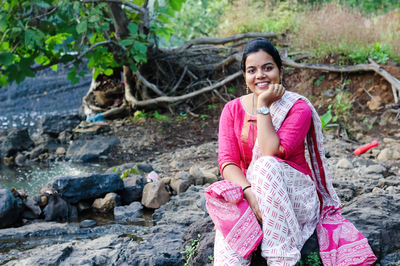 Reflective Indian woman, potential sugar momma, by a river