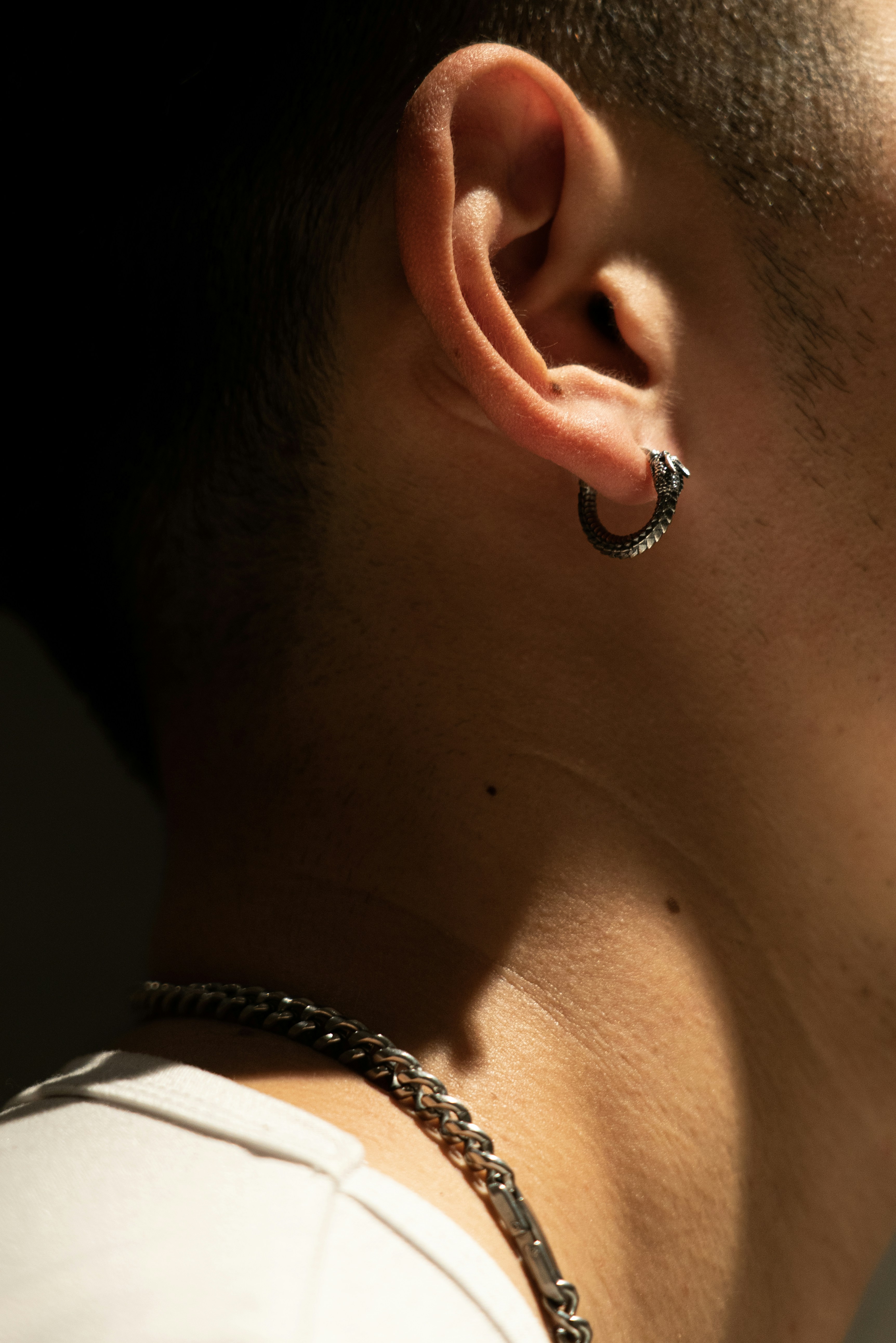 a close up of a person wearing a pair of ear piercings