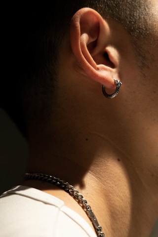 A detailed close-up of a fresh piercing with shiny jewelry in a well-lit studio.