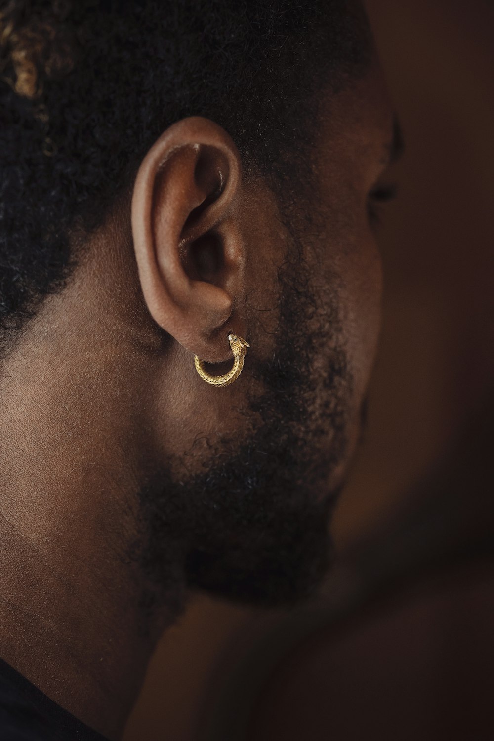 a close up of a person wearing a pair of earrings