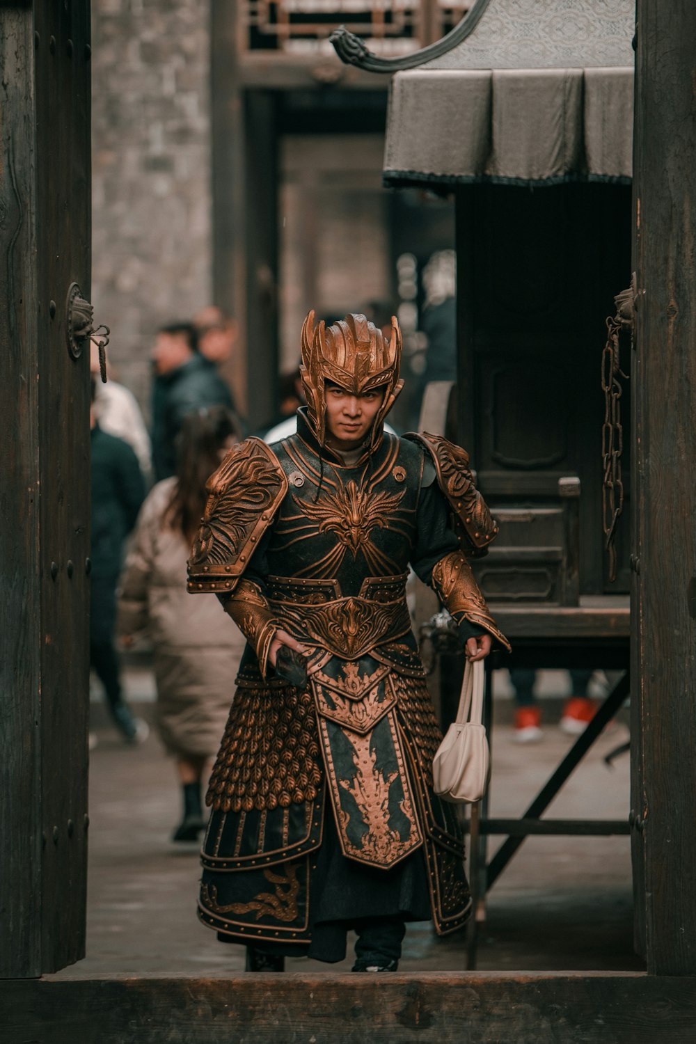 a man dressed in armor and holding a white bag